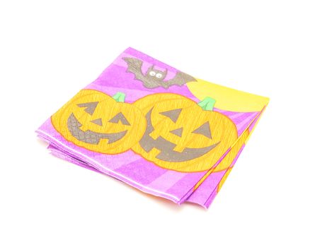 Top view stack of friendly Halloween napkins isolated on white background. Festive party tissue piles display pumpkins, bats, jack-o-lantern