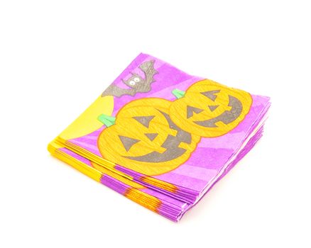 Top view stack of friendly Halloween napkins isolated on white background. Festive party tissue piles display pumpkins, bats, jack-o-lantern