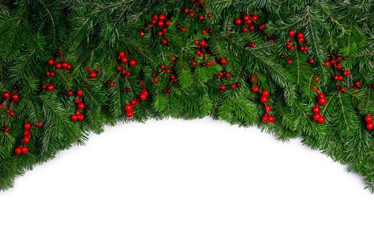 Christmas Border frame of tree branches and red berries on white background with copy space isolated