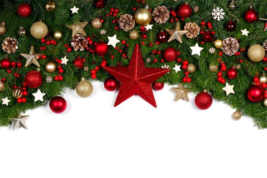 Christmas Border frame of tree branches on white background with copy space isolated, red and golden decor, berries, stars, cones