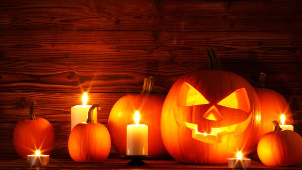 Halloween pumpkin head jack o lantern and candles on wooden background
