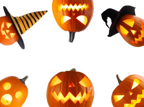 A collection of Jack O Lantern Halloween pumpkins with various different designs and witches hat in a row isolated on white background