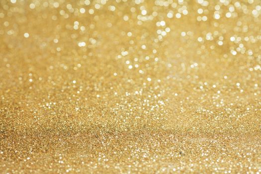 Shiny golden bokeh glitter lights abstract background, Christmas New Year party celebration concept