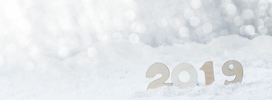 2020 New Year in snow design concept. Wooden 2020 New Year horizontal template with silver glitter backgound