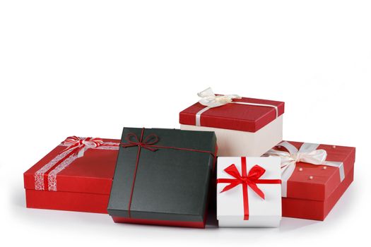 Boxes with gifts tied with ribbons and bows isolated on white background