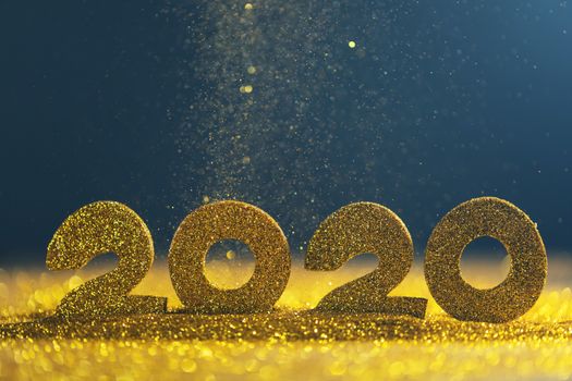 2020 New Year luxury design concept. Golden 2020 New Year horizontal template with golden glitter on blue backgound