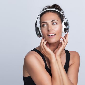 Beautiful woman with headphones, she is listening to the music