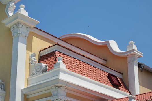 Roof tile pattern on classic house over blue sky