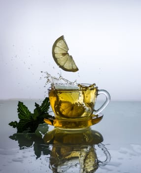 still life of Cup of tea with lemon and splash