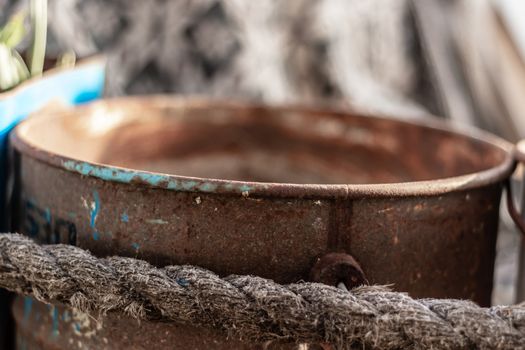 a closeup shoot to antique rusty metal bucket with old ropes around it. photo has taken at izmir/turkey.