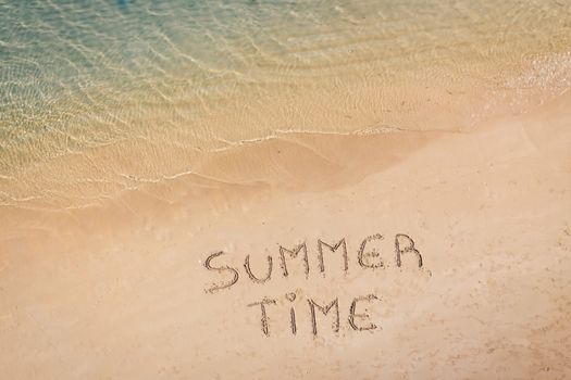 aerial view of the inscription on the sand "Summer Time", Caribbean beach and ocean seen from above