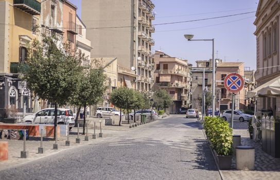 View of a street in the village of Gela with its daytime life in the south of Sicily in Italy.