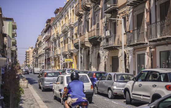 View of a street in the village of Gela with its daytime life in the south of Sicily in Italy.