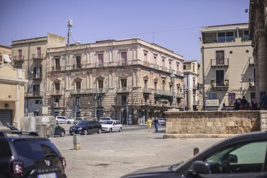 View of a street in the village of Gela with its daytime life in the south of Sicily in Italy.