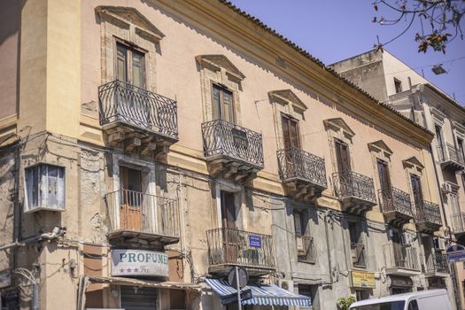 View of a street in the village of Gela with its daytime life in the south of Sicily in Italy.