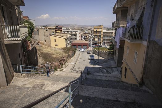 View of a street in the village of Gela with its daytime life in the south of Sicily in Italy.