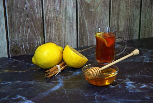 Cold medicine, hot tea with lemon, honey and cinnamon. Close-up.