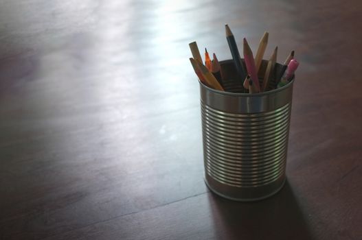 Pen and pencils in tin can, wood table , Concept Back to school