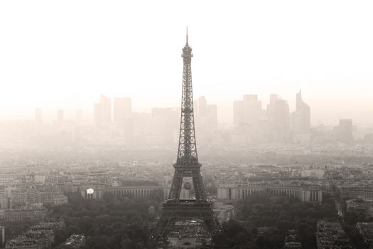 Aerial view of Paris with Eiffel tower and major business district of La Defence in background at sunset.