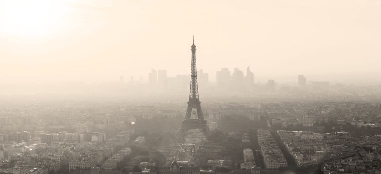 Aerial view of Paris with Eiffel tower and major business district of La Defence in background at sunset. Sepia toned monocrome image.