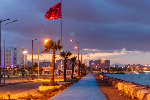 a good looking nightscape shoot of mavisehir coast - there is turkish flag and good looking city under clouds. photo has taken from izmir/turkey.