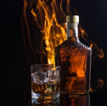 Alcoholic drink in front of warm fireplace. Cozy relaxed magical atmosphere near fire.
