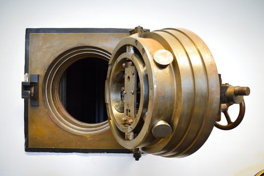 a heavy brass bank vault door sitting open