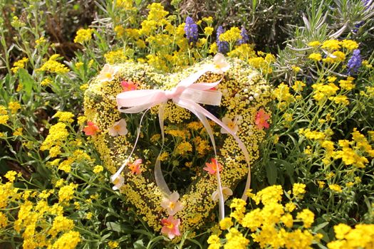 The picture shows a romantic heart in spring flowers.