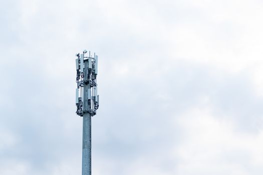 top of telecommunication tower against cloudy sky.