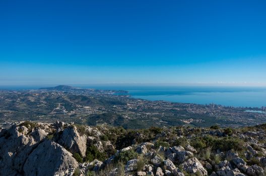 Panoramic view to Mediterranean sea and Calp area from cliffs on mountain range Serra d'Oltà, Spain