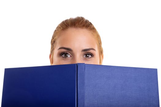 Close-up shot of a young girl covering half of her face with a book, isolated on white background.