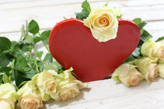 The picture shows a red heart and white roses.