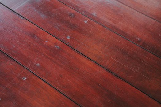 The Natural light brown wooden parquet floor boards. Sunny soft yellow texture, copy space perspective background.