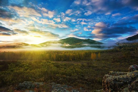 Sunrise in Altai mountains nature reserve. The beginning of autumn, September