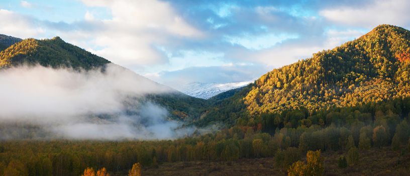 Panoramic picture of sunrise in Altai mountains nature reserve. The beginning of autumn, September