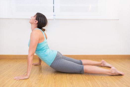 Attractive fit woman wearing sportswear working out at home