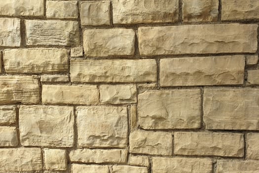 A stone wall of raw stone. Texture of stone.