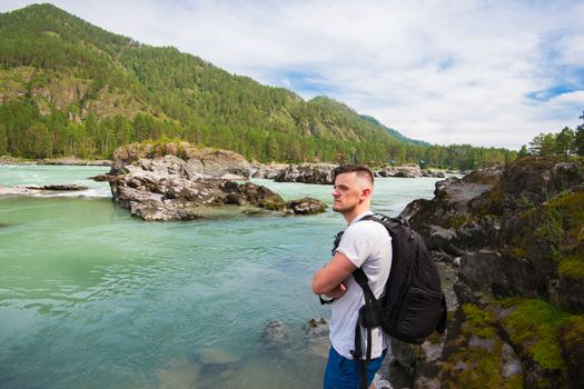 Man resting at river in Altai Mountains territory