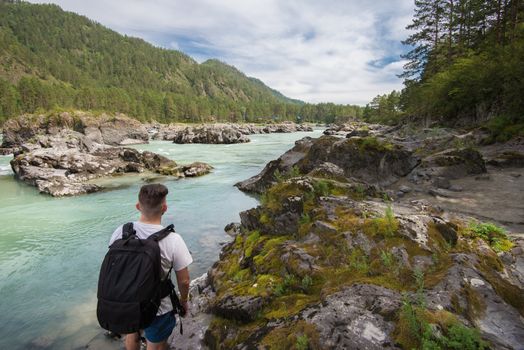 Man resting at river in Altai Mountains territory