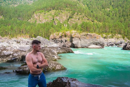 Man resting at river in Altai Mountains territory