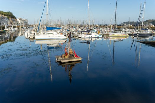 Sea and yachts during tide on sea shore of France in summer