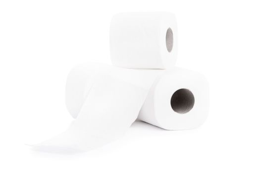 Close up shot of three blank rolls of toilet paper, isolated on white background.