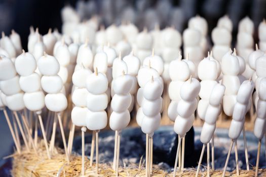 Mochi on a sticks, sweet rice cake dessert, at Nishiki market, Kyoto, Japan