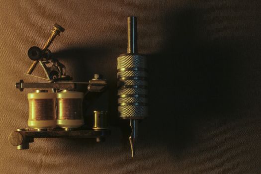 tattoo machine, with accessories and needles, tubes made in color background