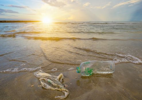 garbage the beach sea plastic bottle lies on the beach and pollutes the sea and the life of marine life Spilled garbage on the beach of the big city. Empty used dirty plastic bottles