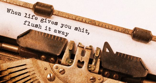 When life gives you shit, flush it away, written on an old typewriter, vintage