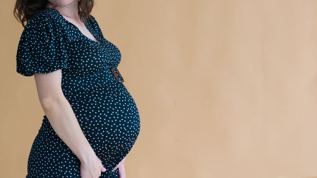 pregnant young woman in dark dress