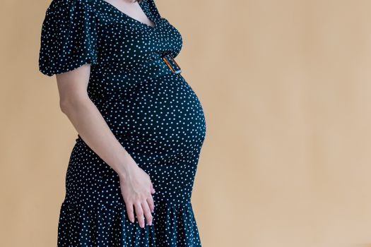 pregnant young woman in dark dress