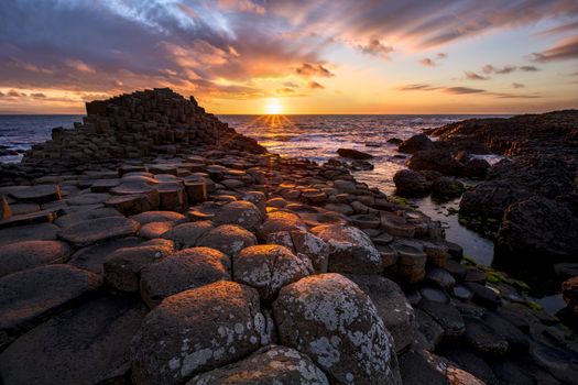 sunset over basalt columns Giant's Causeway known as UNESCO World Heritage Site, County Antrim, Northern Ireland