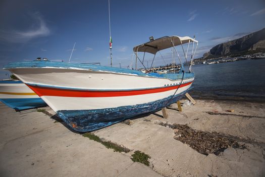 Coloured Boat stranded on the shore 
